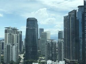 Urban city skyline with tall glass skyscrapers against a blue sky at Conlay